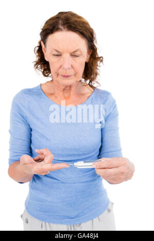 Mature woman using blood glucose monitor Stock Photo