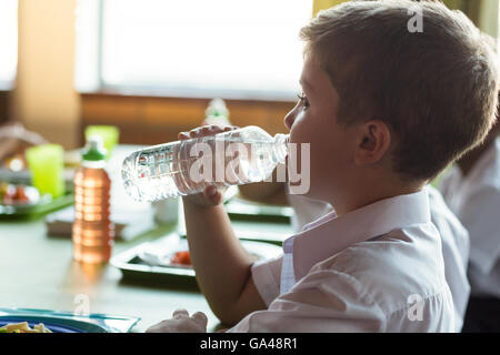 Close-up of schoolboy drinking water Stock Photo