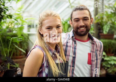 Portrait of happy gardeners at greenhouse Stock Photo