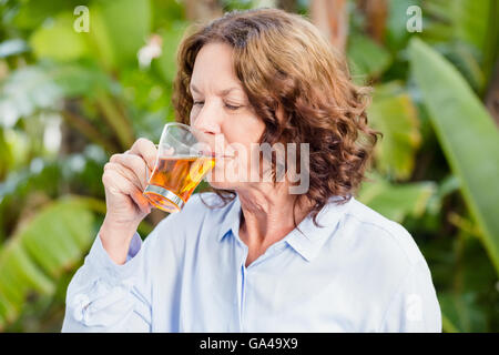 Mature woman drinking herbal tea Stock Photo