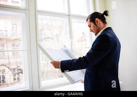 Interior designer looking at blueprint Stock Photo