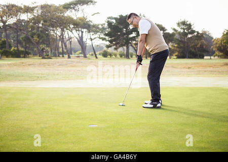 Profile view of sportsman playing golf Stock Photo