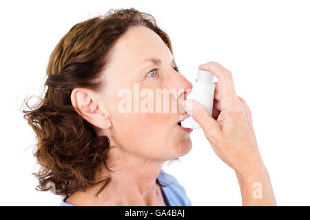 Close-up of mature woman using asthma inhaler Stock Photo