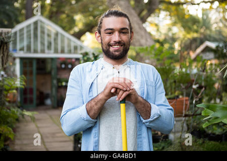 Portrait of happy gardener with work tool at garden Stock Photo