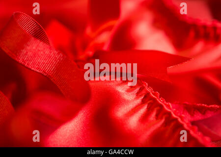Red satin or silk cloth with red lace and close up of stitching Stock Photo