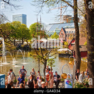 Copenhagen, Denmark - Tourists and the pond with water jets at Tivoli Gardens famous amusement park in Copenhagen Stock Photo
