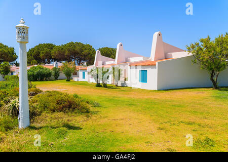 Garden with typical holiday houses in Alvor town, Algarve region, Portugal Stock Photo
