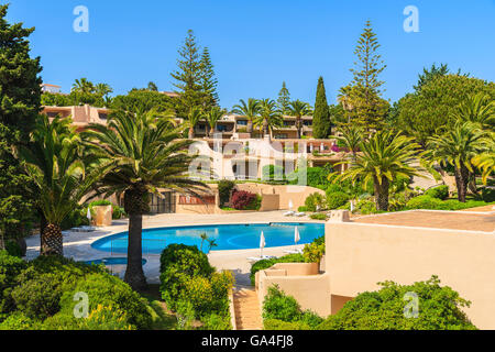 Swimming pool in complex of typical holiday apartments in Armacao de Pera town, Algarve region, Portugal Stock Photo