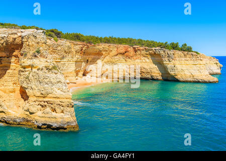 View of beautiful beach with crystal clear turquoise water near Carvoeiro town, Algarve region, Portugal Stock Photo