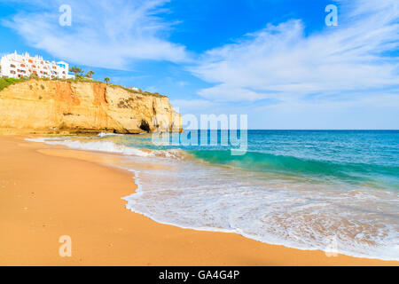 Ocean wave on sandy beach in Carvoeiro holiday village, Algarve region, Portugal Stock Photo