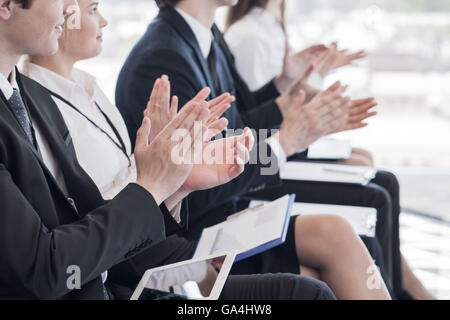 Happy business group of people clapping hands during a meeting conference Stock Photo