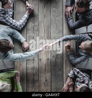 Hipster business people shaking hands, teamwork brainstorming planning meeting concept Stock Photo
