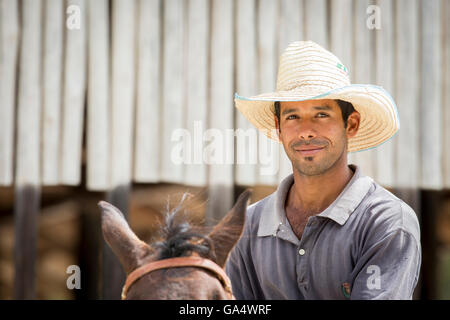 Handsome young Cowboy on horseback at Hacienda La Belen, a working ranch and popular birding area in Cuba Stock Photo