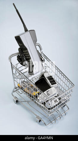 Shopping basket full of old cell phones. Stock Photo