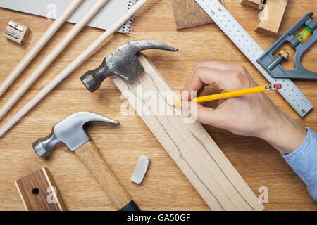 Woodworking workshop table top scene. Making of wooden handle for hammer. DIY concept. Stock Photo