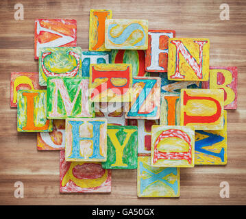 Colorful alphabet, wooden uppercase letters placed in a box, white ...