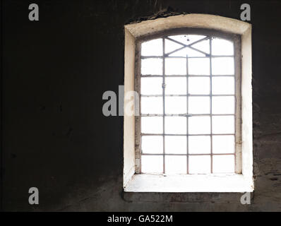 sunlight through old window on the wall Stock Photo