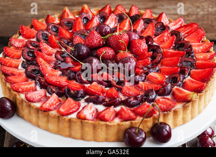 Summer tart with custard cream, fresh cherry and strawberry Stock Photo