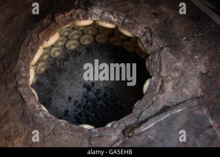 Kashgar. 2nd July, 2016. Photo taken on July 2, 2016 shows nang, a kind of crusty pancake, staple food of the Kashgar people, sticking inside a heated brick oven in Kashgar, northwest China's Xinjiang Uygur Autonomous Region. Bakers spent over 16 hours making around four or five thousand nangs to meet the needs as the breaking fast is approaching. © Bu Duomen/Xinhua/Alamy Live News Stock Photo