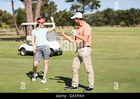 Smart golfer couple celebrating success Stock Photo