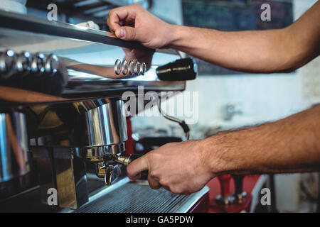 Close-up of barista using espresso machine at coffee house Stock Photo