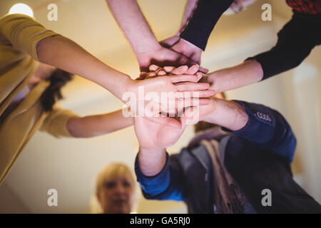 Creative business people stacking hands in office Stock Photo