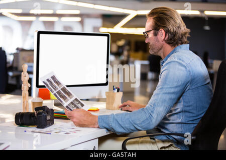 Photo editor working on computer Stock Photo