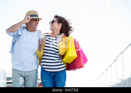Smiling couple against sky in city Stock Photo
