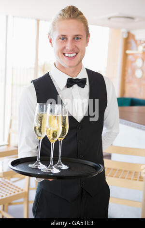 Portrait of waiter holding glasses of champagne Stock Photo