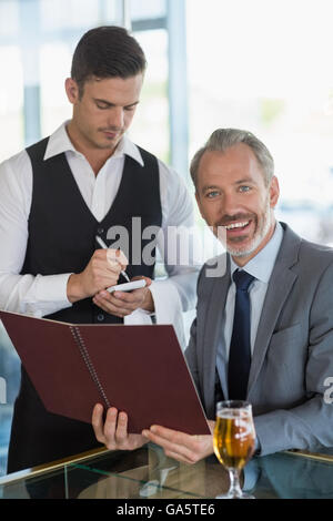 Waiter taking the order from a businessman Stock Photo