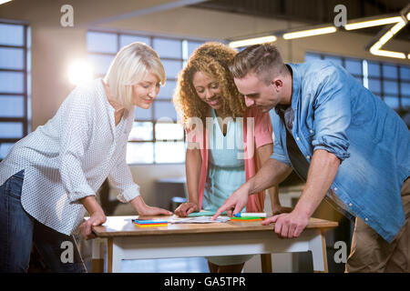 Business people discussing over documents at desk Stock Photo