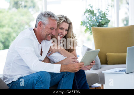 Smart mature couple using digital tablet Stock Photo