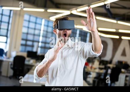 Young businessman using virtual reality simulator Stock Photo
