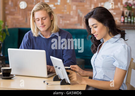 Business colleagues using laptop and digital tablet Stock Photo