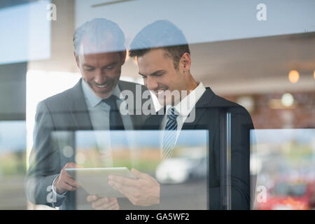 Two businessmen using digital tablet Stock Photo