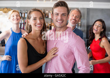 Portrait couple embracing each other in restaurant Stock Photo