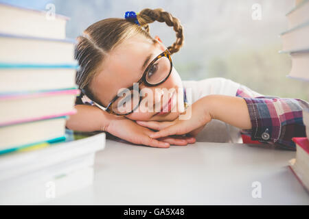 Close-up of schoolkid leaning on desk in classroom Stock Photo