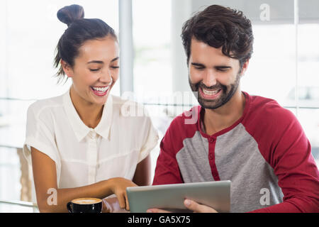 Couple using digital tablet in cafe Stock Photo