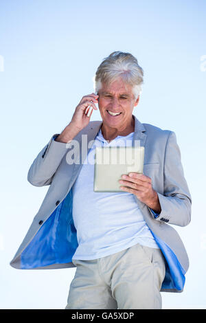 Mature man using digital tablet Stock Photo