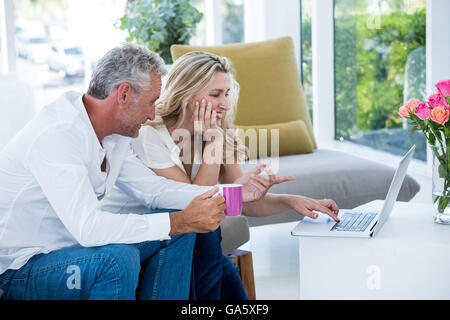 Happy mature couple using laptop Stock Photo