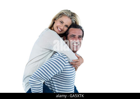 Portrait of man carrying woman piggyback Stock Photo