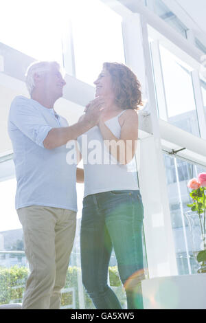 Happy couple dancing at home Stock Photo