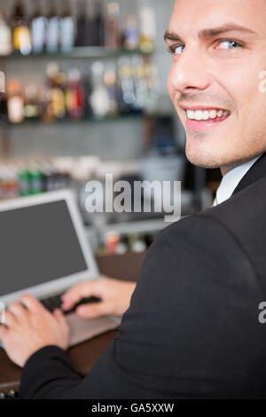 Businessman using laptop in restaurant Stock Photo