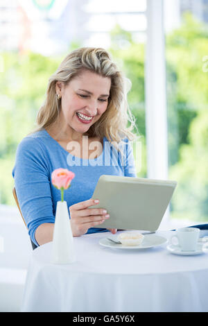 Happy mature woman using digital tablet Stock Photo
