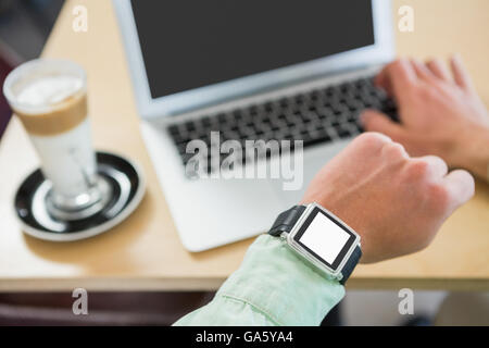 Man checking time on his smartwatch Stock Photo