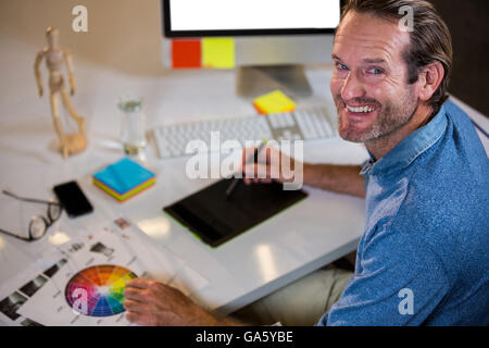 Portrait of businessman using graphics tablet Stock Photo