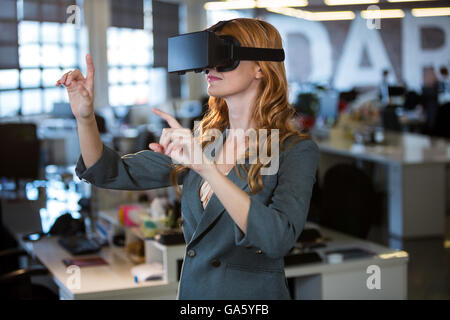 Businesswoman using virtual reality simulator Stock Photo