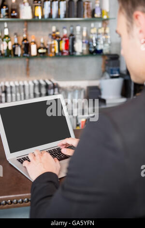 Businessman using laptop in restaurant Stock Photo