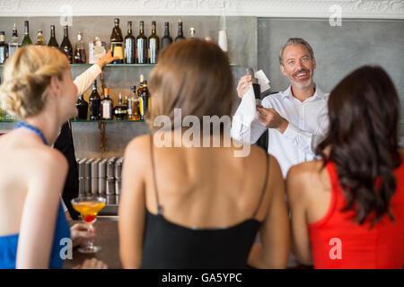 Female friends ordering drinks Stock Photo