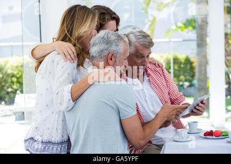 Friends using digital tablet Stock Photo